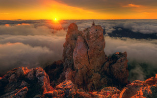 Mountain top sunset clouds figure - top of a rock free wallpaper