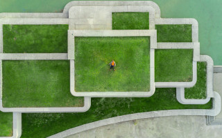 Man walking park green bench - a lush green park free wallpaper