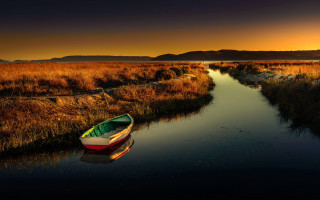 Marshy boat sunset mountain cinematic - a mountain range in the background free wallpaper for desktop