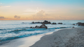 Beach rocks water clouds sky - a few wave free wallpaper