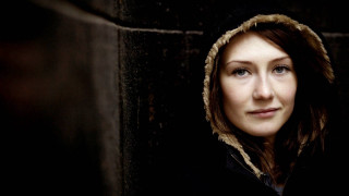 Woman hooded jacket serious expression - her face and shoulders free wallpaper