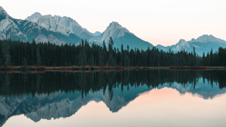 Mountain range reflection lake forest - the foreground and a forest in the background free wallpaper