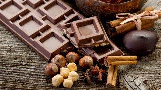 Chocolate nuts cinnamon wooden table - a chocolate bar free wallpaper