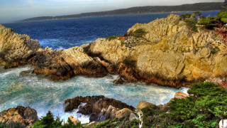 Rocky coastline water trees cliff - a body of water and trees free wallpaper
