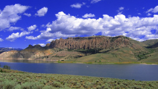 Lake mountains clouds sheep grassland - a few sheep free wallpaper