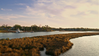 River boat grassy sunset cityscape - a grassy area in the foreground free wallpaper