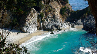 Waterfall cliff ocean beach nature - a sandy beach free wallpaper for desktop