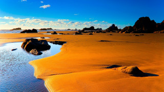 Sandy beach rocks water blue - a sandy beach free wallpaper for desktop