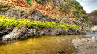Rocky cliff river grassy trees - a river running free wallpaper