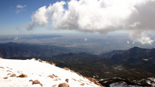 Mountain range cloudy sky snow - a few rock below free wallpaper
