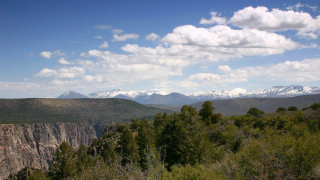 Mountain range trees clouds snow 2 - panoramic free wallpaper