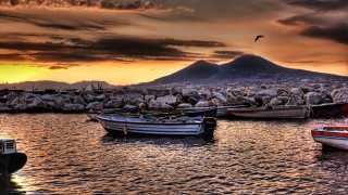 Boats lake snowy mountains cityscape - a rocky shore free wallpaper for desktop