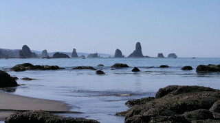 Beach rocks water hill sky - a hill in the distance free wallpaper
