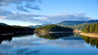 Lake mountains trees cloudy sky 22 - tree and mountains under a cloudy sky free wallpaper for desktop