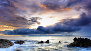 Sunset ocean cloud rocks boat - a boat in the distance free wallpaper