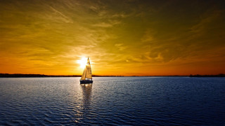 Sailboat sunset beach water reflection - the distance behind free wallpaper