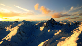 Snowy mountain range cloudy sunset - snow under a cloudy sky free wallpaper