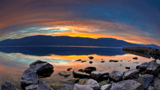 Lake rocks dock mountains sky - a colorful sky free wallpaper