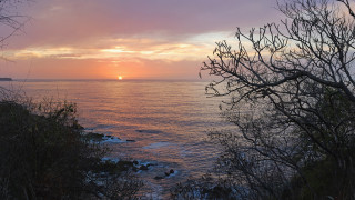 Sunset ocean tree boat mountain - a sunset over the ocean free wallpaper