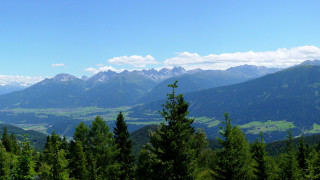 Mountain range valley trees beach - a view of a mountain range free wallpaper