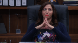 Woman sitting chair hands folded - feminist free wallpaper