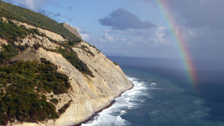 Rainbow ocean cliff beach mountains - free seasons wallpaper