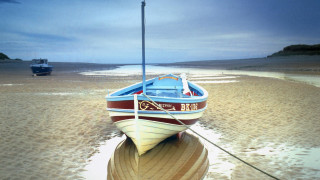 Boat beach ocean cloudy sky - a sandy beach next free wallpaper