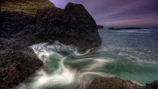 Rock formation wave purple sky - rich moody colour free wallpaper