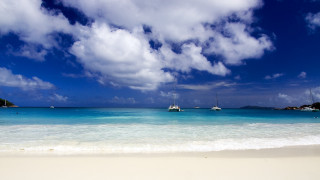 Beach boats clouds sand sky - a white sand beach free wallpaper
