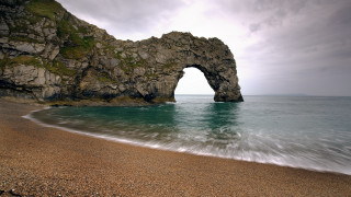 Rock formation beach ocean arch - a body of water in front free wallpaper