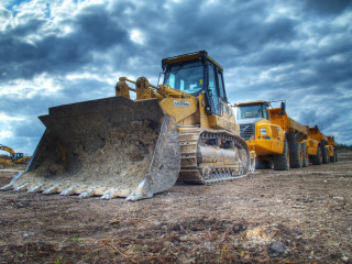 Bulldozer parked field cloudy sky - free cats wallpaper for desktop