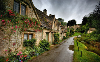 Stone houses flower lined street - a wet road free wallpaper for desktop