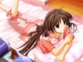 Girl bed cellphone remote modern - a remote control free wallpaper