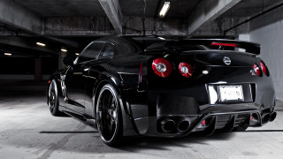 Black sports car parking garage 11 - the rear end of the car free wallpaper