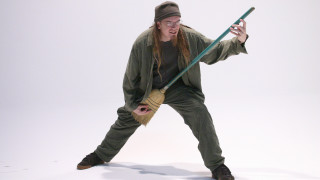 Man green outfit holding pole - a green jacket free wallpaper