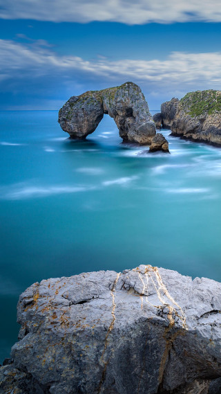 Rock formation ocean bridge blue - free nature wallpaper for mobile