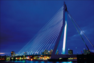 Tall bridge tower night city - a city skyline in the background free wallpaper