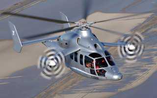 Helicopter flying sandy beach ocean - a helicopter free wallpaper