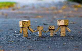 Cardboard figures holding hands road - the ground behind them free wallpaper for desktop