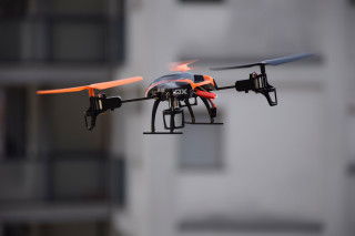 Small black red drone camera - free technology wallpaper