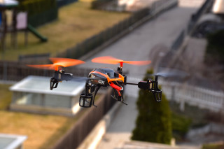 Orange black drone flying city - product photo free wallpaper for desktop
