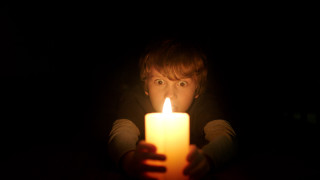 Creepy person holding candle dark - their hand in free wallpaper