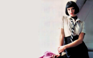 Woman skirt shirt tie purse - leaning against a wall free wallpaper