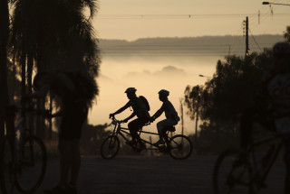 Biking group forest fog sunset - a foggy sky in the background free wallpaper for desktop