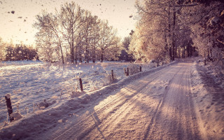 Snowy road fence trees winter - a snowy road free wallpaper