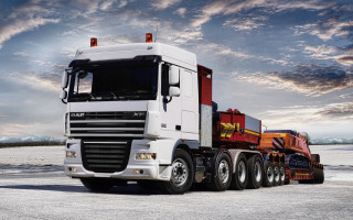 Semi truck trailer snowy scene - a sunbeam in the background free wallpaper