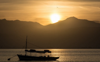 Boat lake sunset mountains bird - over the water free wallpaper