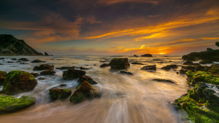 Sunset rocky beach waves foreground - a rock formation in the foreground free wallpaper