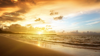 Sunset ocean beach clouds mountain - a sunset over the ocean free wallpaper