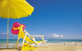 Yellow umbrella pink hat beach - a beach chair free wallpaper